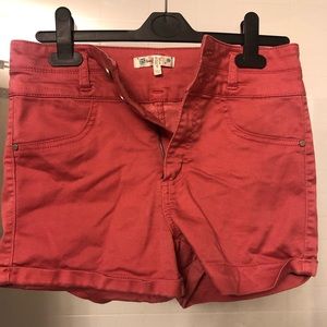 Bright orange high rise shorts